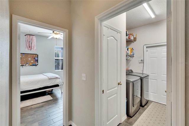 washroom with a ceiling fan, separate washer and dryer, laundry area, and light wood-type flooring
