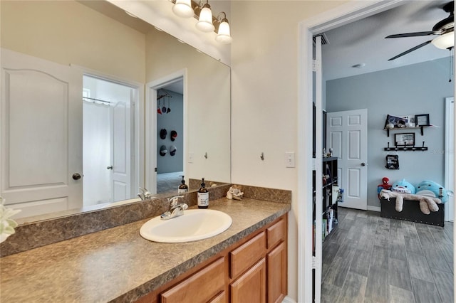 bathroom with vanity, wood finished floors, and a ceiling fan