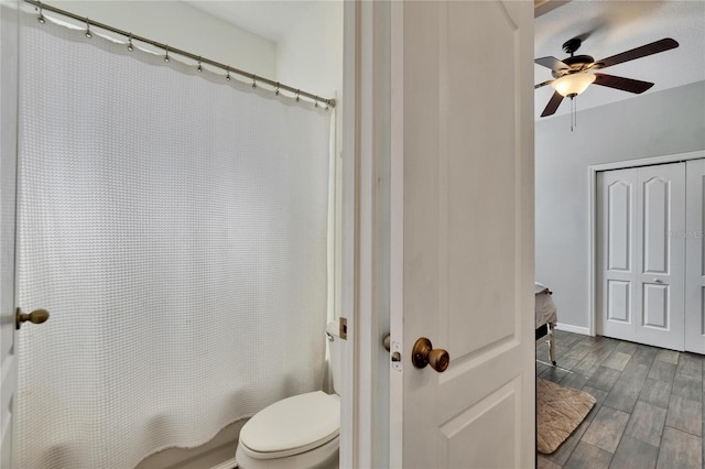 bathroom with ceiling fan, toilet, and wood finished floors