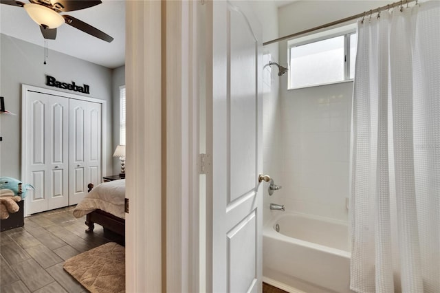 ensuite bathroom featuring ceiling fan, shower / tub combo with curtain, ensuite bathroom, and wood finished floors