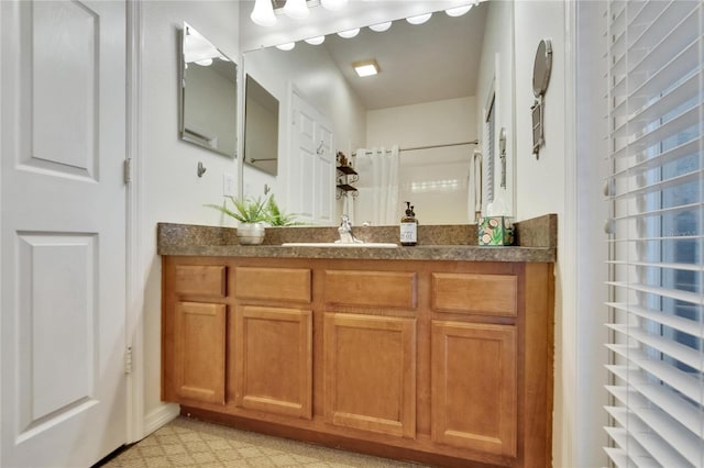 bathroom with walk in shower and vanity