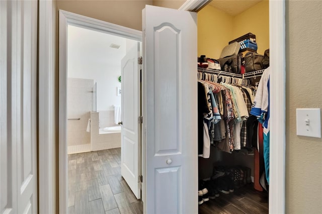 walk in closet featuring visible vents and wood finished floors