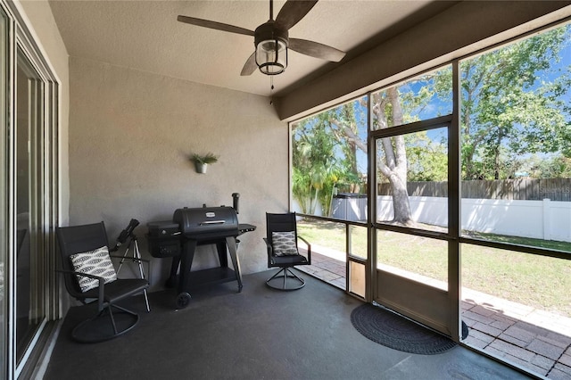 sunroom featuring ceiling fan and plenty of natural light