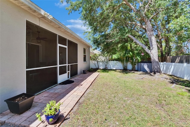 view of yard with a patio, a sunroom, and a fenced backyard