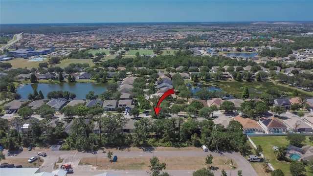 birds eye view of property with a water view and a residential view