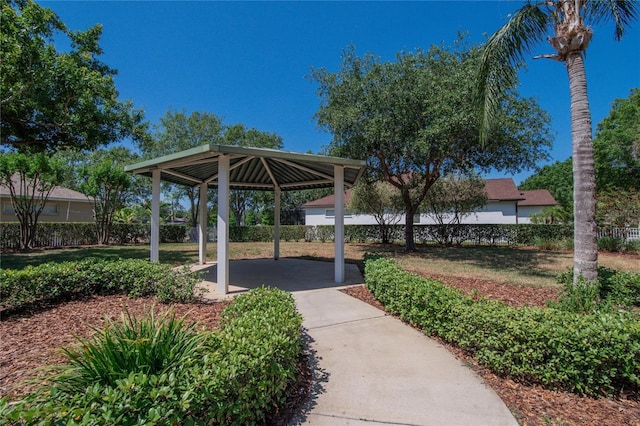 view of community featuring a gazebo, a patio area, fence, and a carport