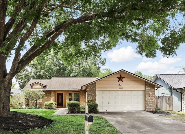 ranch-style house featuring driveway, a front yard, fence, brick siding, and a garage