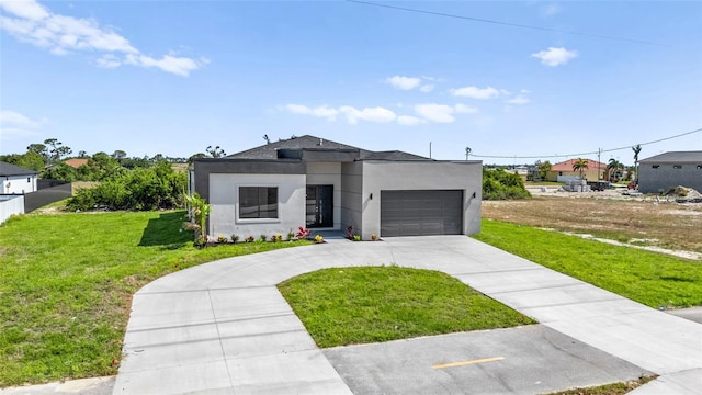 contemporary home featuring an attached garage, stucco siding, driveway, and a front yard
