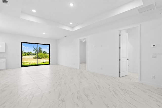 spare room featuring visible vents, a raised ceiling, baseboards, marble finish floor, and recessed lighting