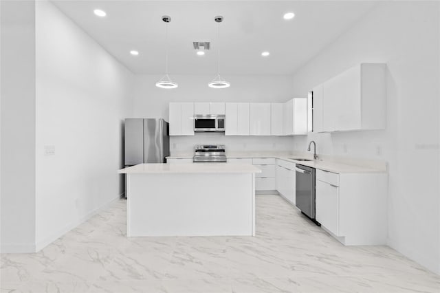 kitchen featuring a sink, marble finish floor, stainless steel appliances, white cabinetry, and visible vents