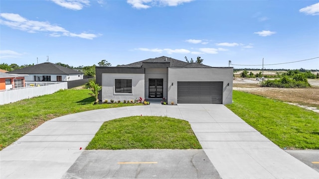 view of front facade featuring a garage, fence, a front lawn, concrete driveway, and stucco siding