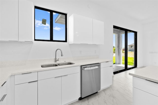 kitchen with modern cabinets, stainless steel dishwasher, a sink, white cabinets, and marble finish floor