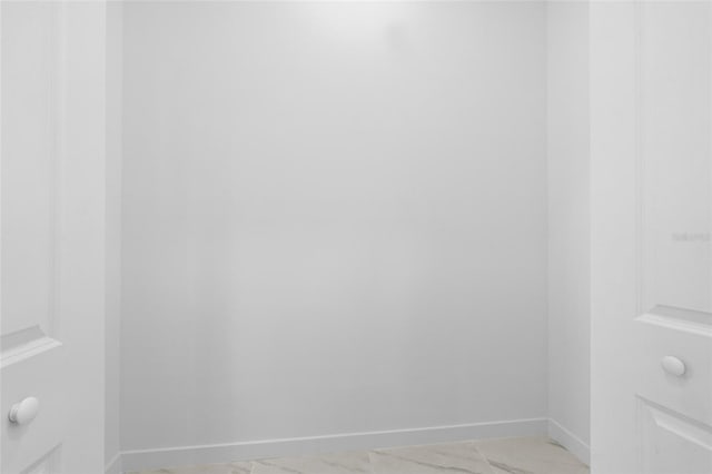 interior space featuring baseboards