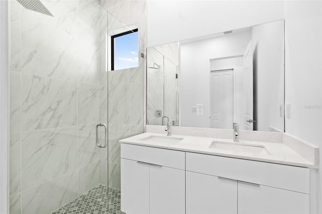 full bathroom featuring double vanity, a sink, and a marble finish shower