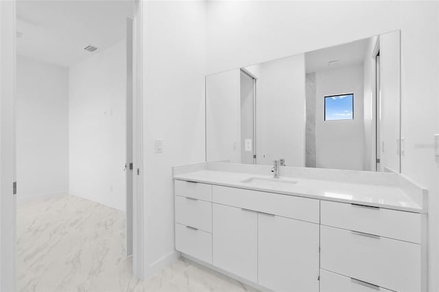bathroom with baseboards, visible vents, vanity, and marble finish floor