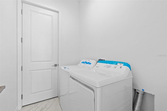 laundry area with laundry area, marble finish floor, and washer and dryer