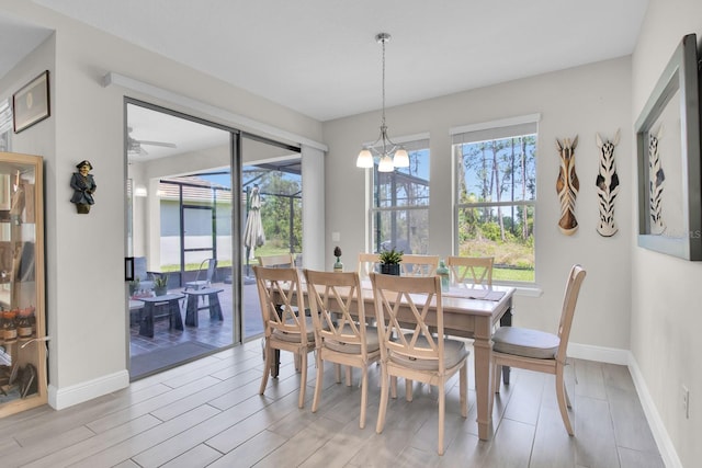 dining room with baseboards, light wood-style floors, and plenty of natural light