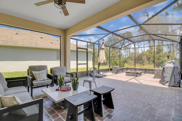view of patio / terrace with an outdoor living space with a fire pit, area for grilling, a ceiling fan, and a lanai