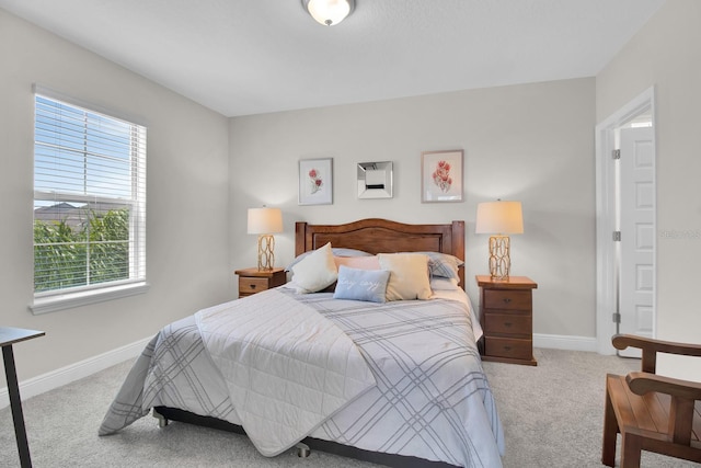 carpeted bedroom with baseboards and multiple windows