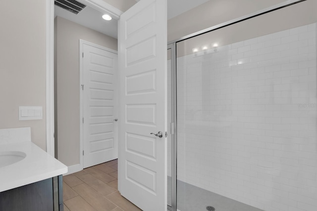 full bathroom with visible vents, vanity, recessed lighting, and a stall shower