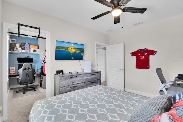 carpeted bedroom with a ceiling fan, visible vents, and baseboards