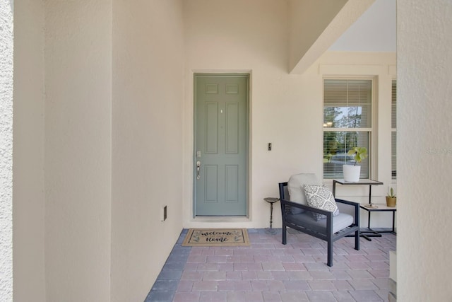 entrance to property featuring stucco siding