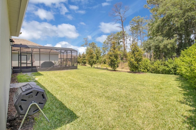 view of yard with glass enclosure