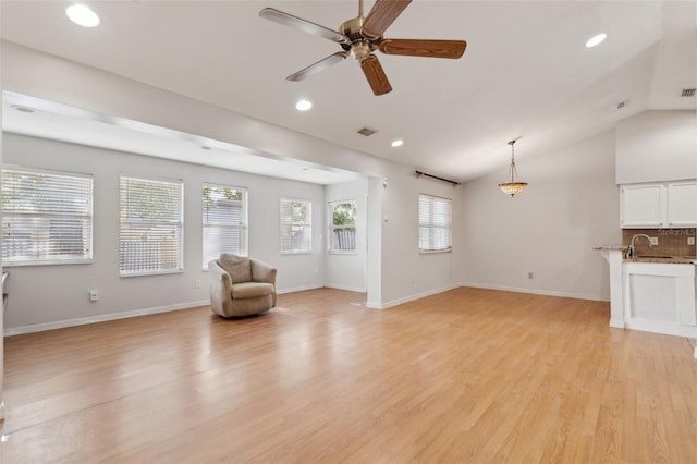 sitting room with a healthy amount of sunlight, ceiling fan, recessed lighting, and light wood finished floors
