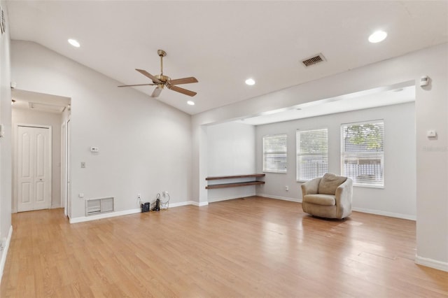 interior space featuring visible vents, ceiling fan, light wood-type flooring, and vaulted ceiling