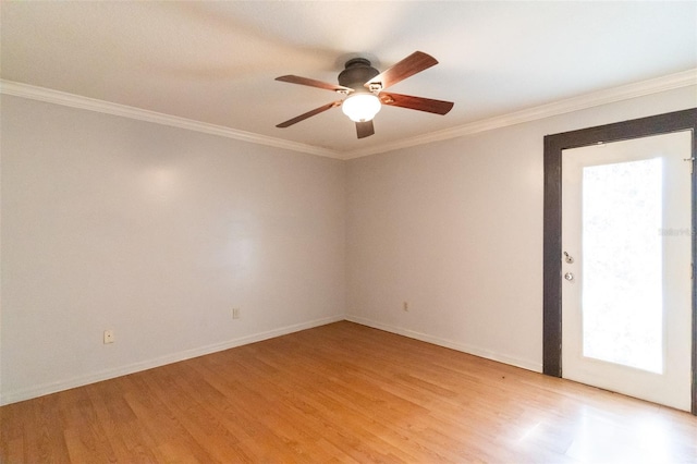 empty room with crown molding, a ceiling fan, light wood-style flooring, and baseboards