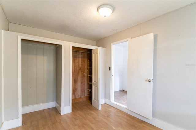 unfurnished bedroom featuring light wood finished floors and baseboards