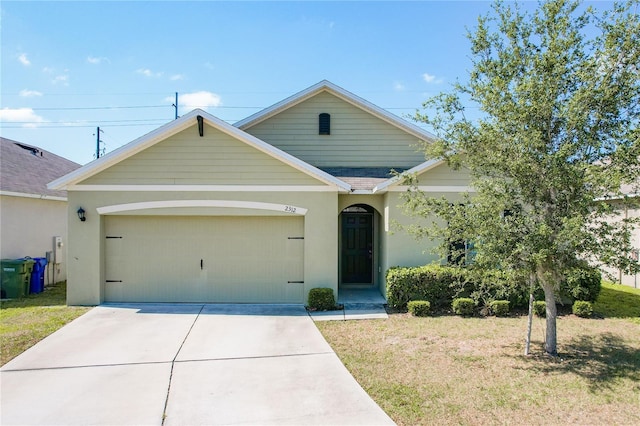 view of front of property featuring concrete driveway, a front yard, an attached garage, and stucco siding