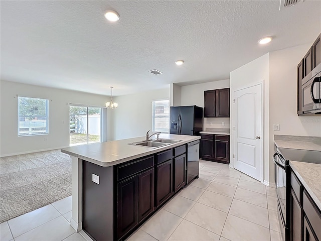 kitchen featuring a chandelier, black appliances, a sink, visible vents, and open floor plan