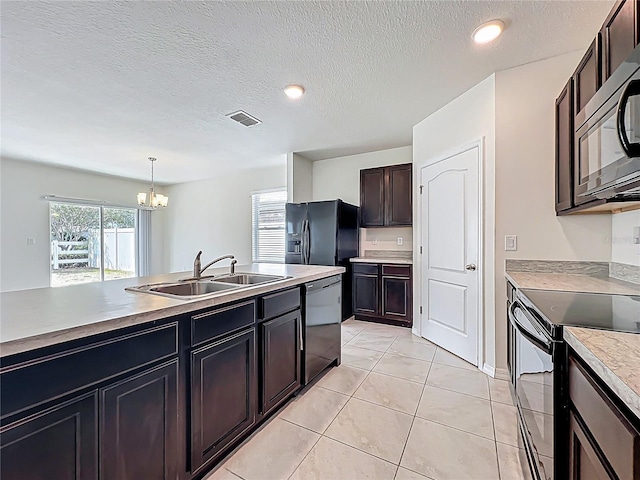 kitchen featuring a sink, a chandelier, black appliances, visible vents, and pendant lighting