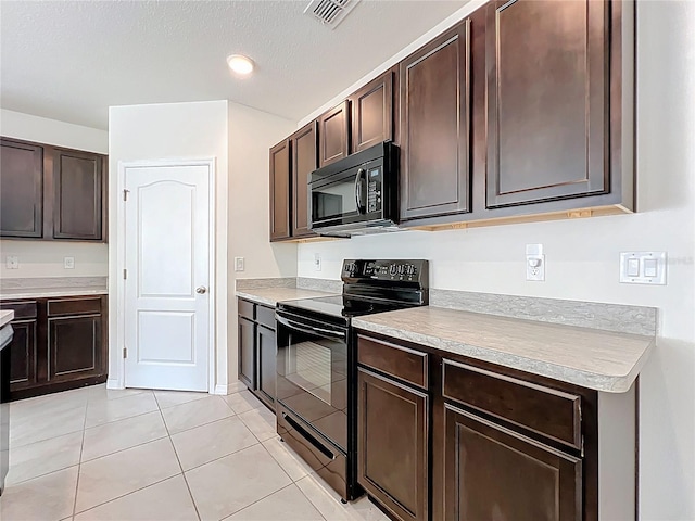 kitchen with visible vents, black appliances, dark brown cabinets, and light countertops