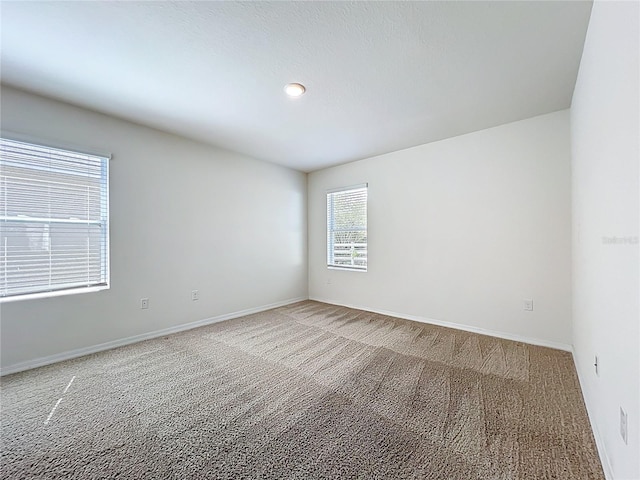 empty room with carpet flooring and baseboards