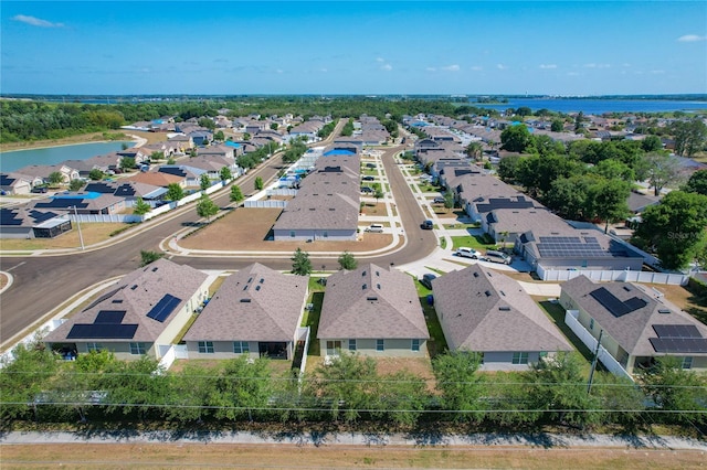 birds eye view of property featuring a water view and a residential view