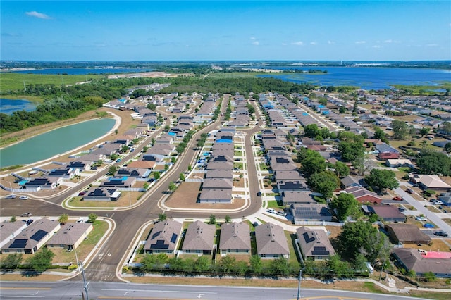 birds eye view of property with a residential view and a water view