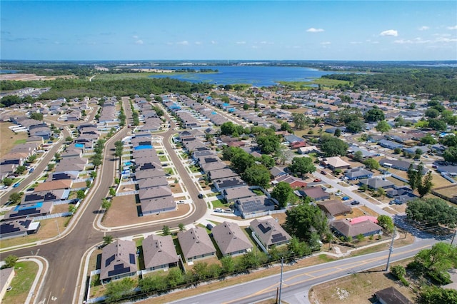 drone / aerial view featuring a residential view and a water view