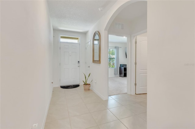 1535 Barberry Dr, Kissimmee, FL 34744 - entryway featuring arched walkways, baseboards, visible vents, and light tile patterned floors