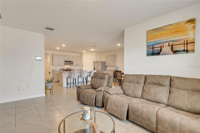 1535 Barberry Dr, Kissimmee, FL 34744 - living area featuring visible vents, recessed lighting, and light tile patterned floors