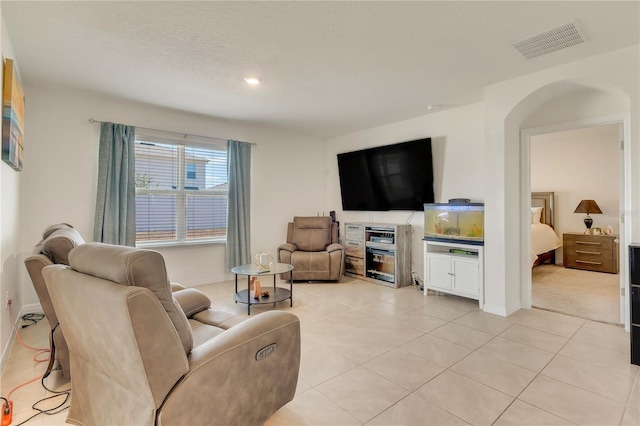 1535 Barberry Dr, Kissimmee, FL 34744 - living area with visible vents, baseboards, recessed lighting, arched walkways, and light tile patterned floors