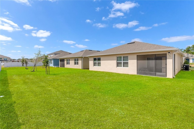 1535 Barberry Dr, Kissimmee, FL 34744 - back of property featuring a sunroom, stucco siding, and a yard
