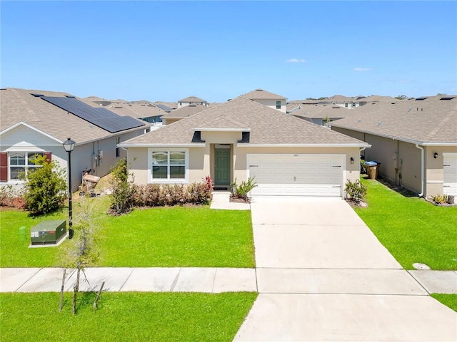 1535 Barberry Dr, Kissimmee, FL 34744 - view of front of property featuring a shingled roof, a front lawn, a garage, stucco siding, and driveway