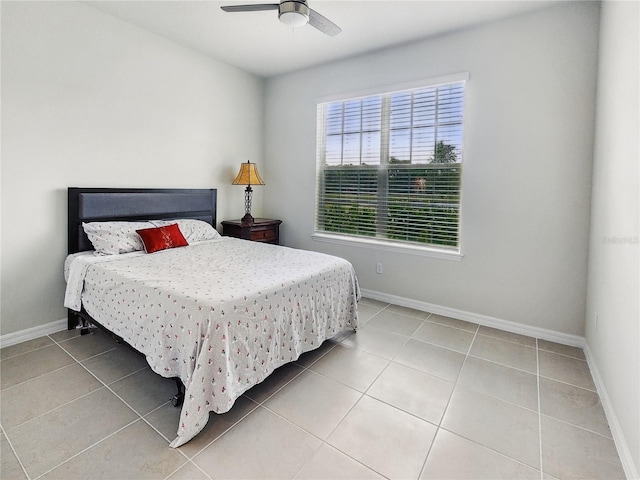 bedroom featuring a ceiling fan, baseboards, and tile patterned flooring
