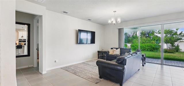 living area featuring light tile patterned floors, baseboards, visible vents, and an inviting chandelier