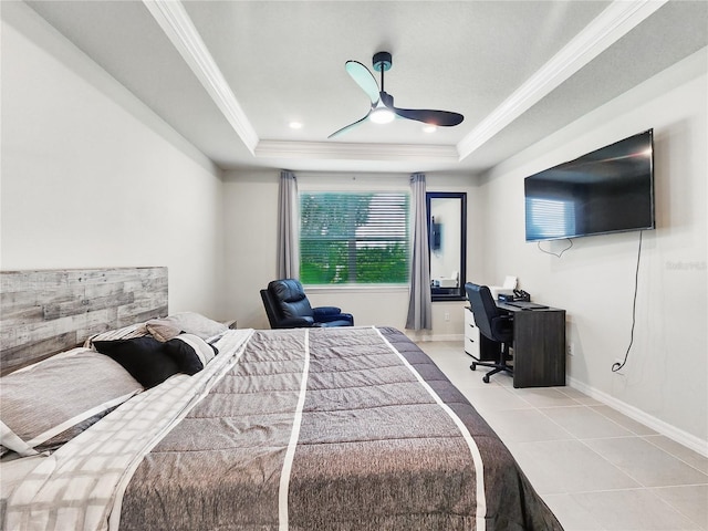 bedroom featuring crown molding, a ceiling fan, tile patterned floors, and a tray ceiling