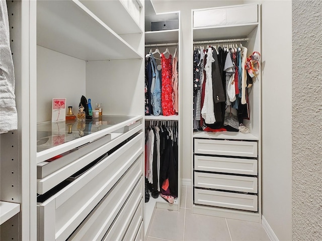 walk in closet featuring tile patterned flooring