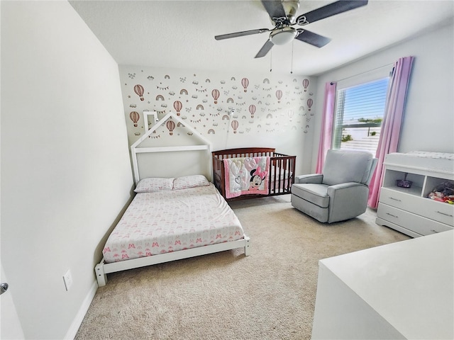 bedroom featuring baseboards, ceiling fan, and carpet
