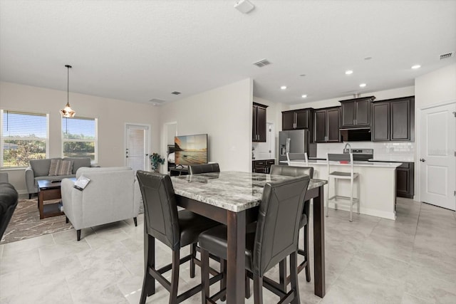 dining room with recessed lighting and visible vents
